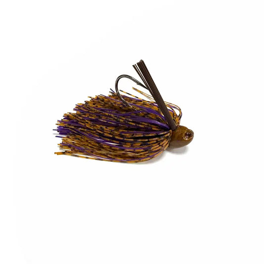 A single fishing lure shown on a plain white background. The lure has a brown head, a dark metal hook with dark brown hair strands, and a skirt made of purple and metallic gold/tan strands.